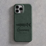Back of a forest green leather iPhone case debossed with a northern pike above Gunnar and PIKE below the camera, on gray plaster