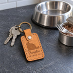 Pumpkin ORANGE CAT keychain in amber leather on a sunlit kitchen counter