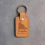 Indian summer amber leather keychain debossed with a heavy sitting cat above the name Pumpkin and ORANGE CAT