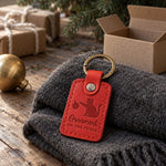Red Ornament on the Floor keychain on a rug beneath a Christmas tree beside a fallen bauble
