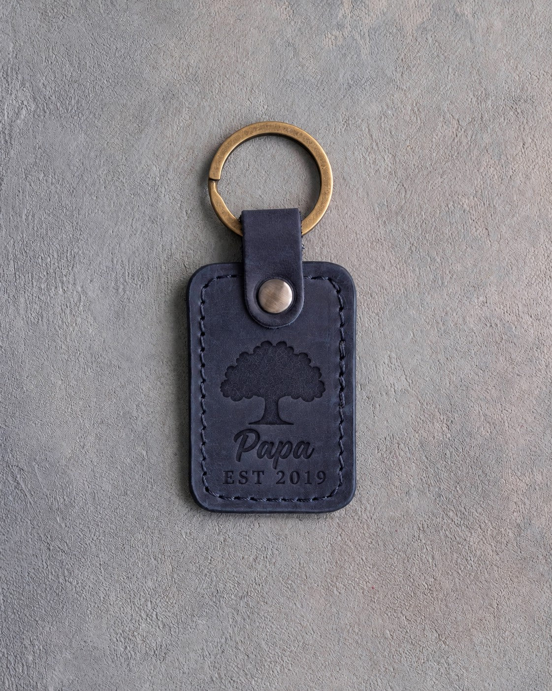 Blueberry navy leather keychain debossed with a solid oak tree above Papa and EST 2019