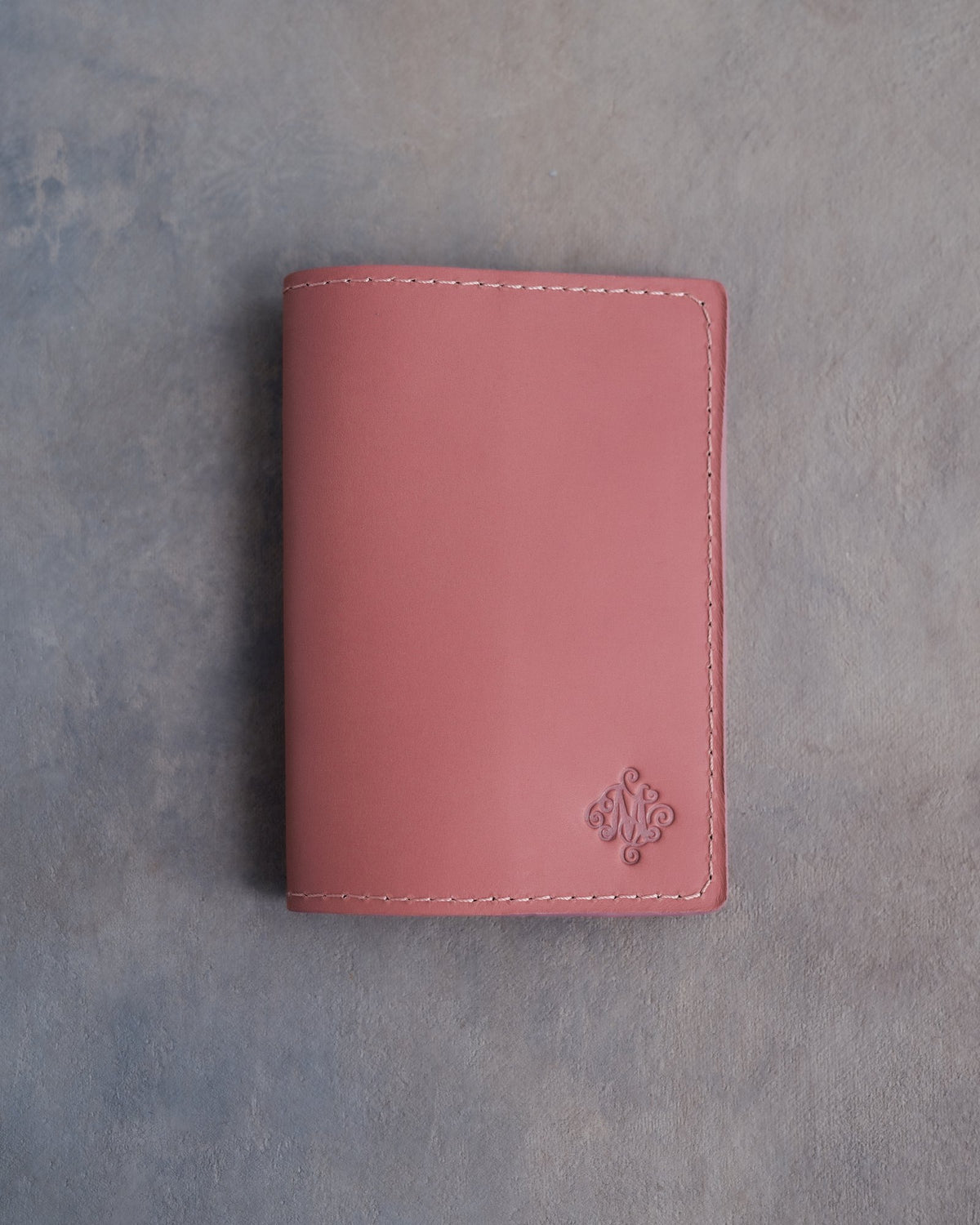 Parisian Blossom leather passport cover with a flower initial pressed into the bottom corner