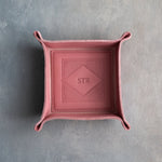Parisian Blossom leather valet tray with snapped corners and the initials STR pressed into the diamond frame, seen from above