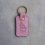 Lilac leather keychain debossed with a fluffy sitting Persian cat above the name Pearl and PERSIAN