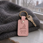 Luna's MOM keychain in blush leather on a ring of house keys resting on a sunny windowsill