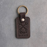 Dark espresso leather keychain debossed with crossed wrenches above Ray's and GARAGE
