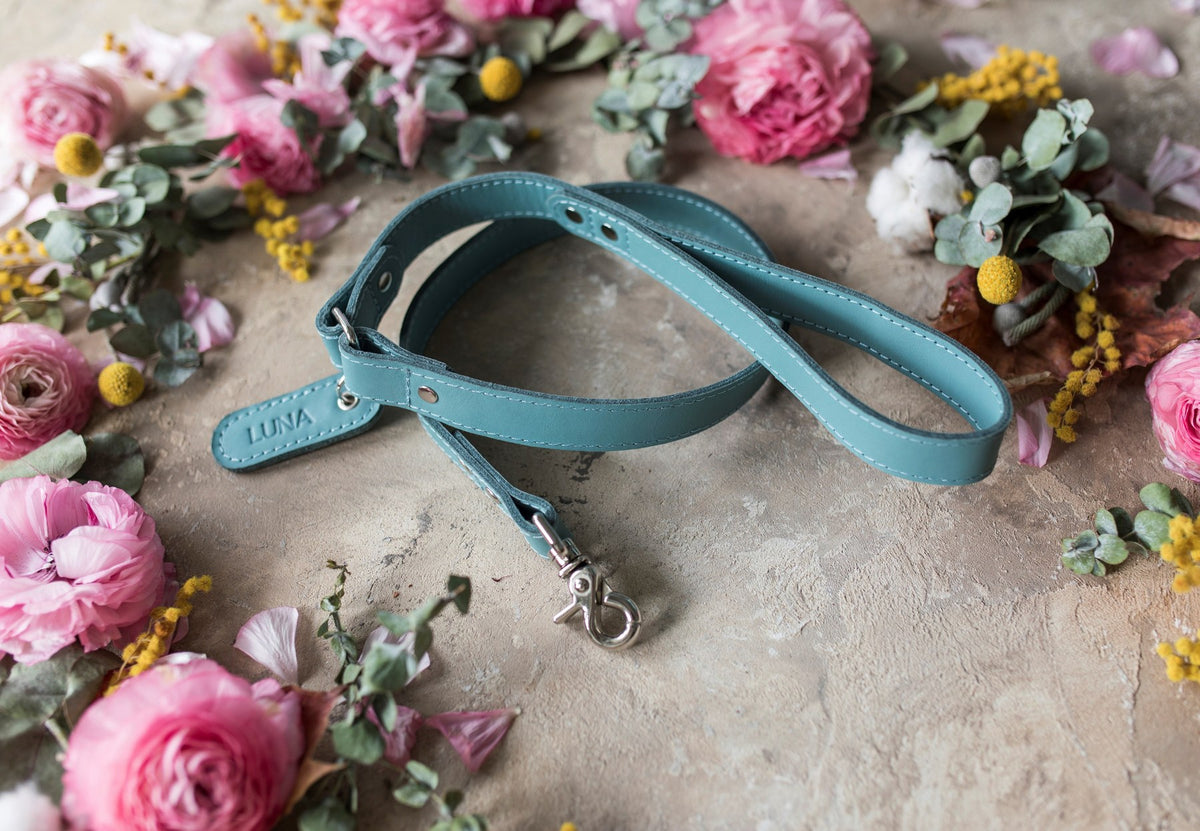Personalized turquoise leather dog leash with a name tab