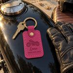 Fuchsia Lena RIDES HER OWN motorcycle keychain on a key ring beside a riding helmet