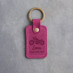 Fuchsia pink leather keychain debossed with a motorcycle above Lena and RIDES HER OWN