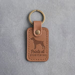 Caramel leather keychain debossed with a German Shorthaired Pointer silhouette and the words Points at EVERYTHING, on gray concrete