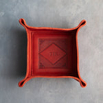 Poppy Red leather valet tray with snapped corners and the initials TJR pressed into the diamond frame, seen from above