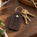 Doug the Pug keychain in dark brown leather with brass house keys on a walnut entry table