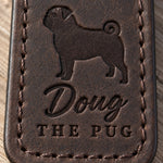 Close-up of the name Doug and THE PUG pressed into dark brown full-grain leather under a pug silhouette