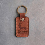 Arizona tan leather keychain debossed with a dachshund wearing antlers and the words Reindeer UNDERSTUDY, on gray concrete