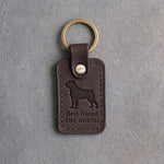 Dark espresso leather keychain debossed with a Rottweiler silhouette above Best friend and THE ROTTIE, on gray concrete