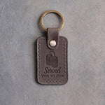 Country gray leather keychain debossed with a pair of dog tags above the words Served and 1988 TO 2008, on gray concrete