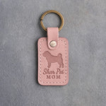 Blush pink leather keychain debossed with a Shar Pei silhouette and the words Shar Pei MOM, on gray concrete