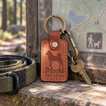 Arizona tan Mochi the Shiba keychain held in a warm everyday setting