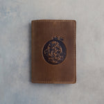 Sicilian Brown leather passport cover with a large floral initial O pressed into the front