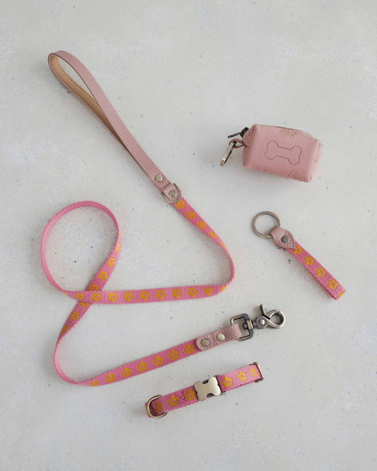 Thin webbing leash in pink and marigold with a matching collar, keychain and leather bag holder