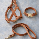 Matching leather dog harness, collar and leash set in Caramel laid flat