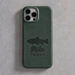 Back of a forest green leather iPhone case debossed with a rainbow trout above Mike and TROUT below the camera, on gray plaster