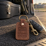 Unpaid Roadie keychain in brown leather on minivan keys resting on a black equipment case