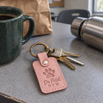 Dr Patel DVM keychain in pink leather on clinic keys beside a stethoscope on an exam room counter
