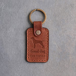 Arizona tan leather keychain debossed with a vizsla above Good dog and THE VIZSLA, on gray concrete