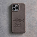 Back of a country gray leather iPhone case debossed with a walleye above Walt and WALLEYE below the camera, on gray plaster