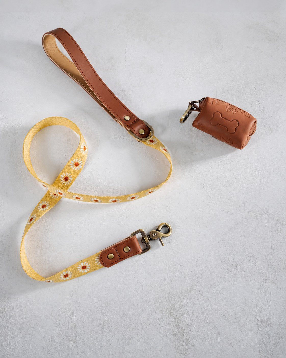 Sunny Daisy woven webbing dog leash with a brown leather handle and matching poop-bag holder
