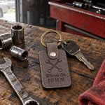Gray Where's the 10MM keychain lying on a red toolbox drawer among loose sockets
