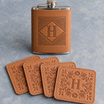 Whiskey gift set: a Caramel leather hip flask with the initial H in a diamond frame and four matching leather coasters with H in a floral frame