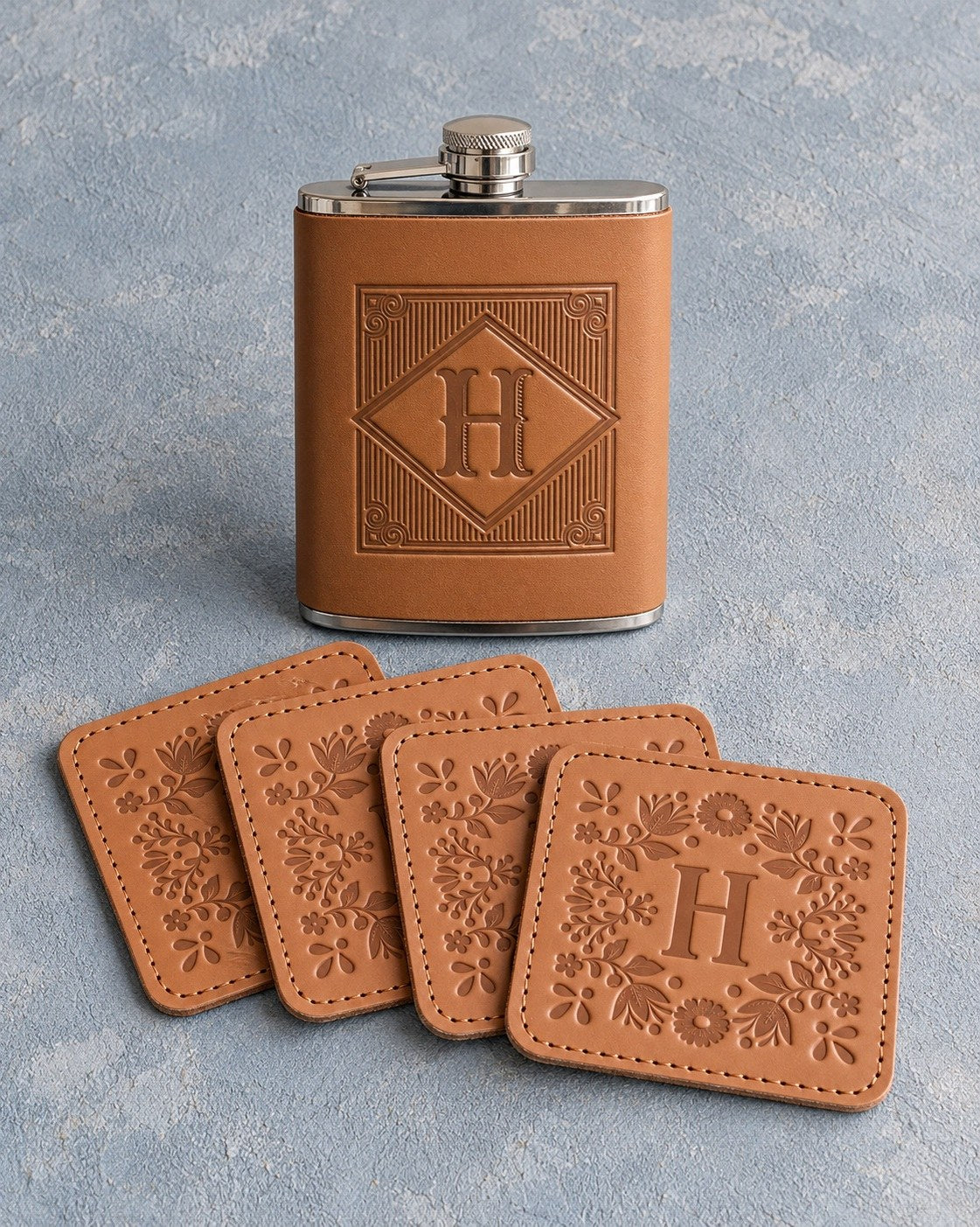 Whiskey gift set: a Caramel leather hip flask with the initial H in a diamond frame and four matching leather coasters with H in a floral frame