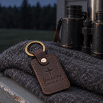 Dark brown North Star keychain on truck keys resting on a folded road map in late afternoon light