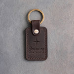 Dark espresso leather keychain debossed with a four-point star above You are my and NORTH STAR, on gray concrete