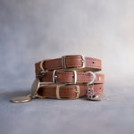 Dog collar in arizona caramel leather with a classy pin buckle and brass ID tag, three stacked