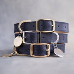 Dog collar in blueberry navy leather with a classy pin buckle and brass ID tag, three stacked