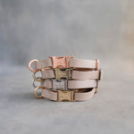 Beige dog collars in Gray Sand full-grain leather, 5/8 in wide, with engraved quick release buckles in four finishes