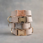 Beige dog collars in Gray Sand full-grain leather, 1 in wide, with quick release buckles engraved with names
