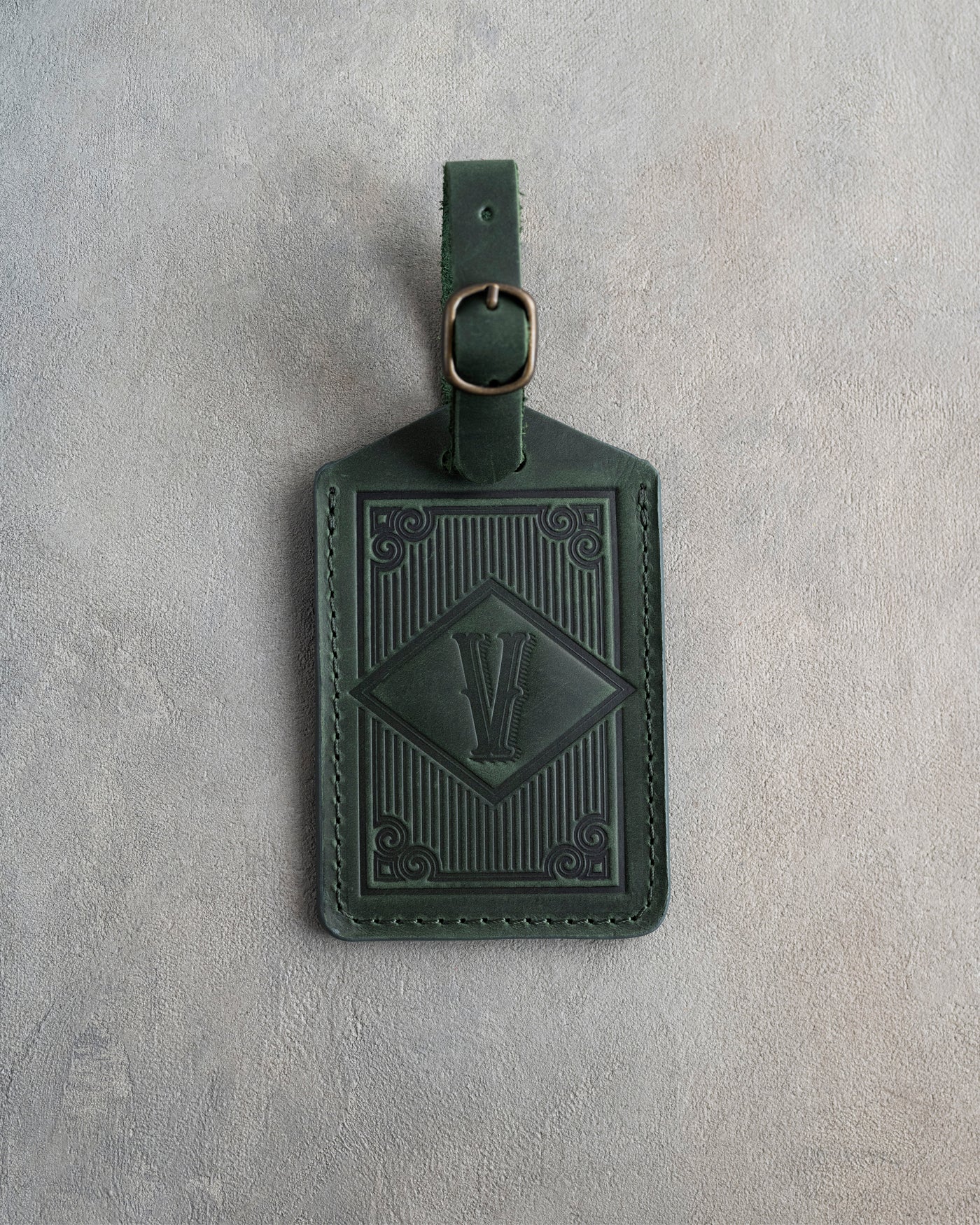Classy initial luggage tag in forest green leather with an art-deco framed monogram