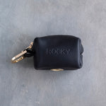 Black leather dog poop bag holder with an engraved name and brass clip