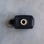 Black leather poop bag holder with a bottom dispensing opening